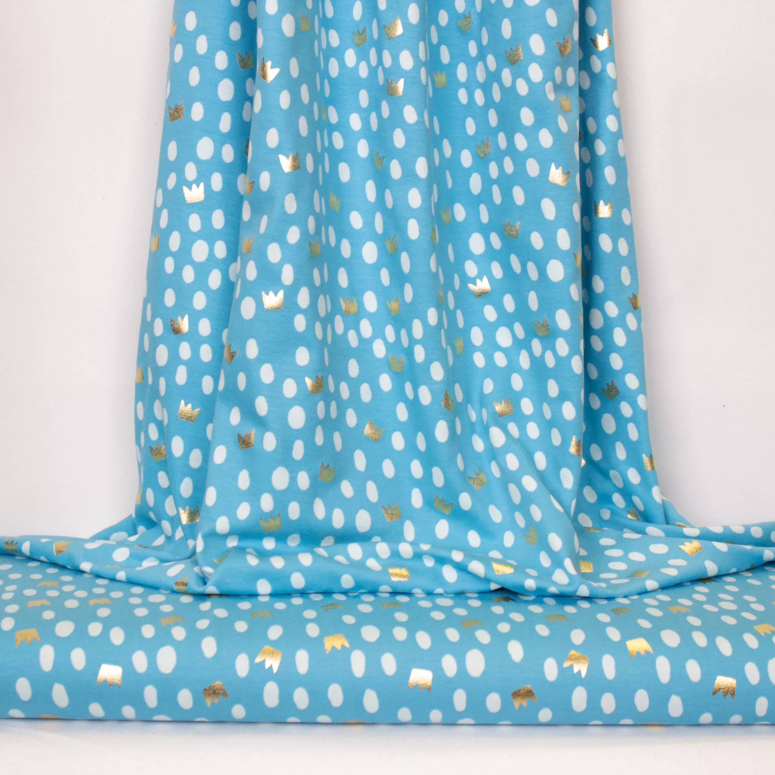 Blauwe tricot met gouden kroontjes en stippen