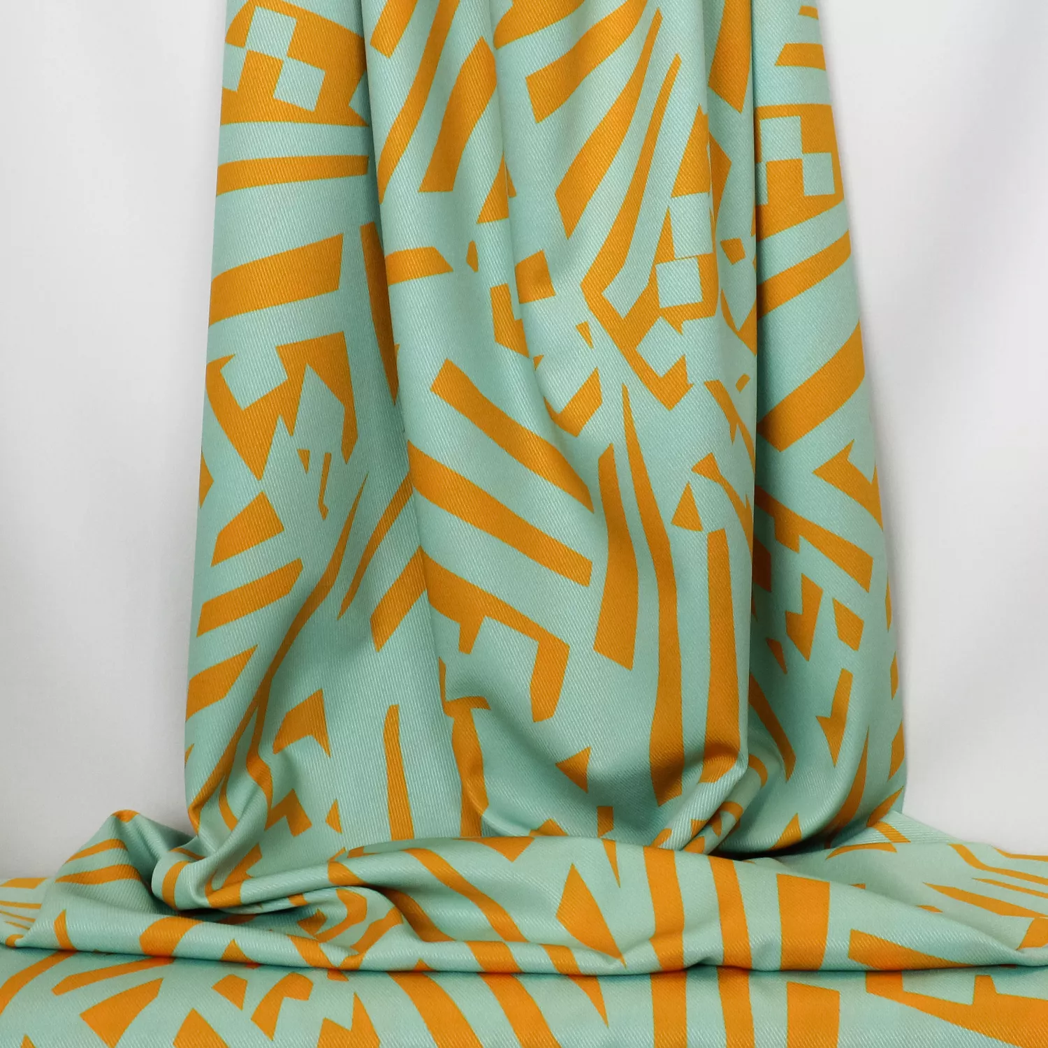 Polyester elasthane turquoise met oker - Burda