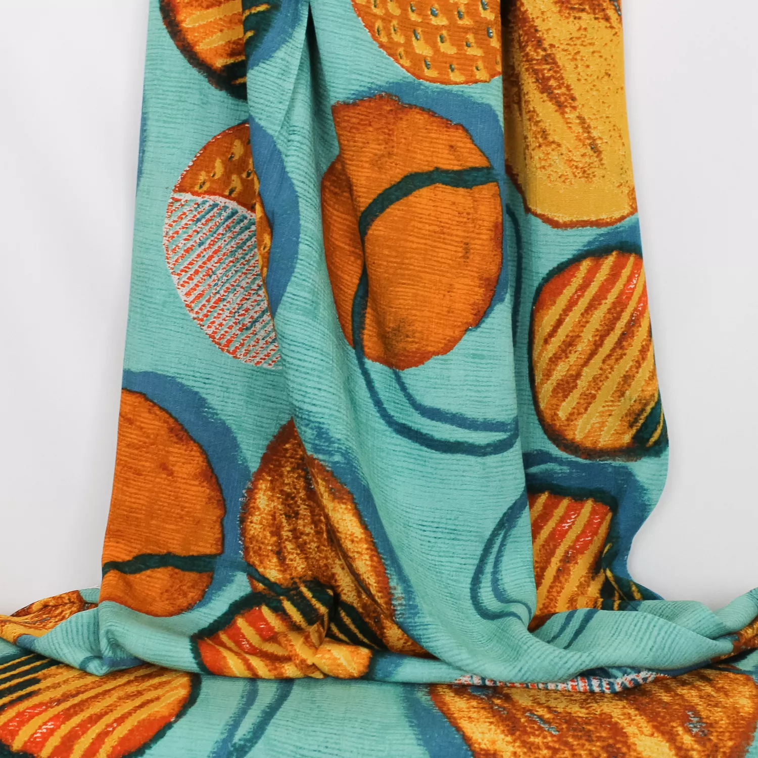 Viscose crêpe blauw met oranje cirkels