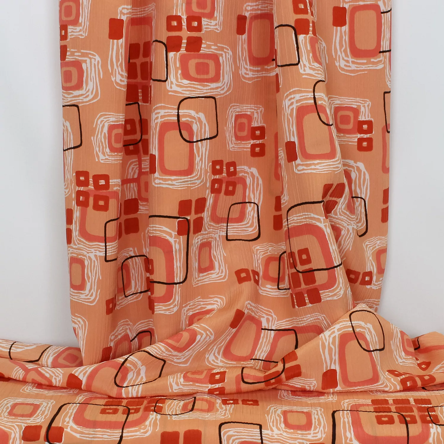 Plissé abrikoos/zalmroze met abstracte print