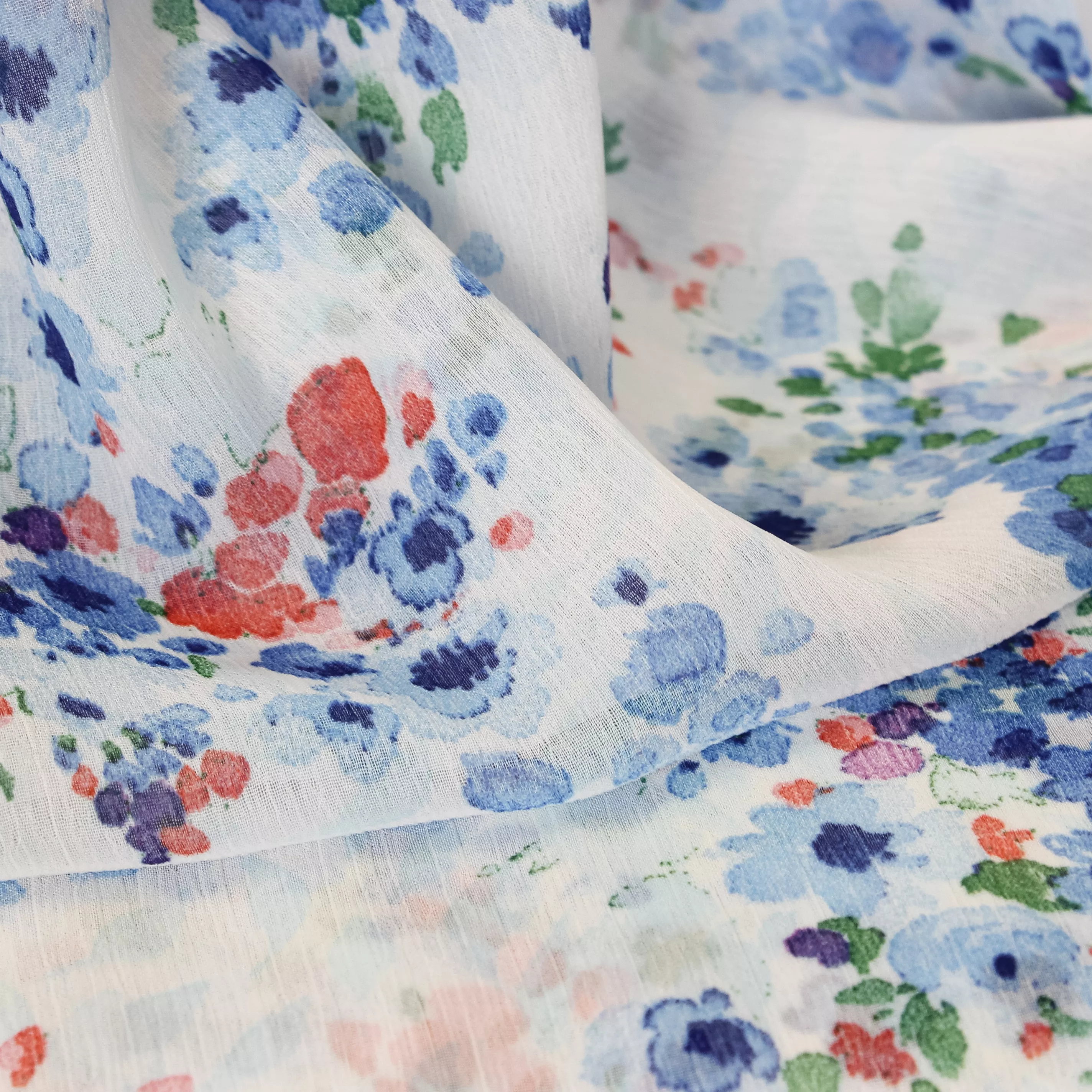 Voile polyester met blauwe en rode bloemen