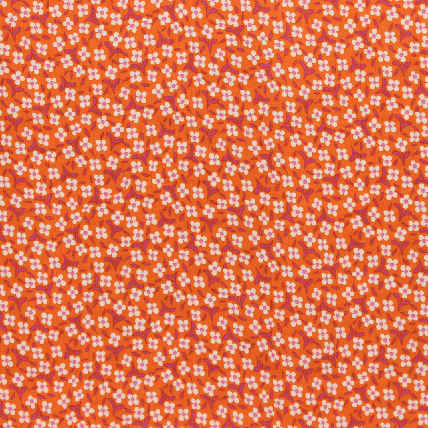 Viscose crêpe oranje met kleine witte bloemetjes  - Knipmode