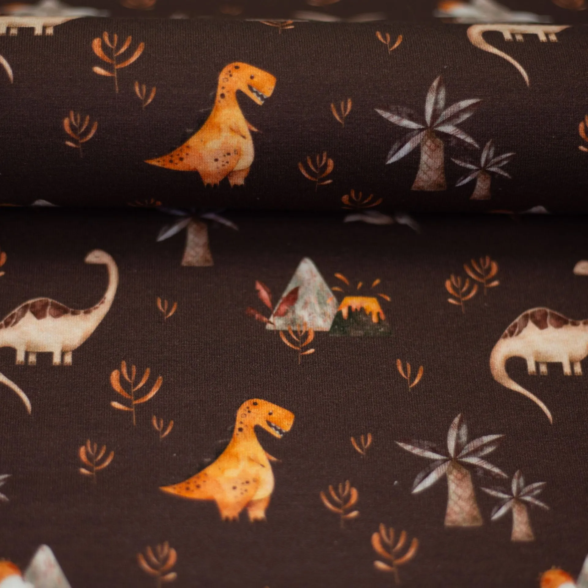 Katoen tricot donkerbruin met dino's