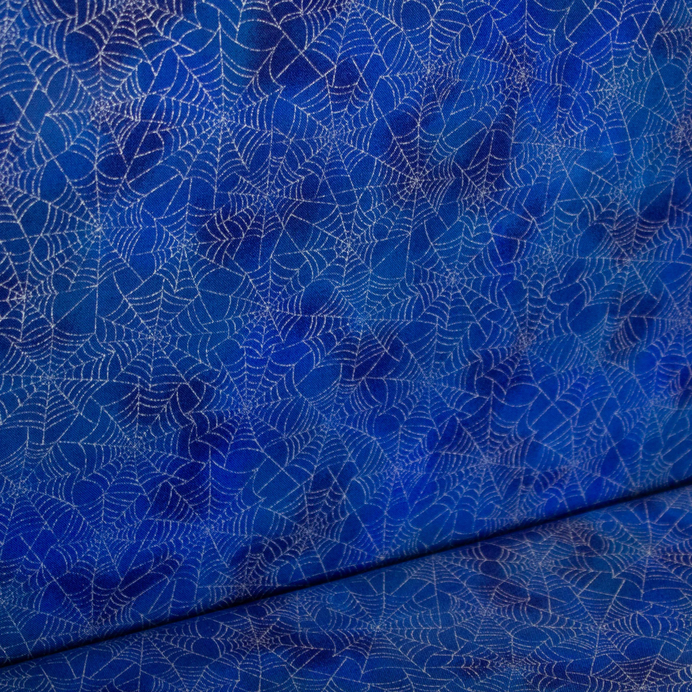 Katoen blauw met metallic spinnenwebben