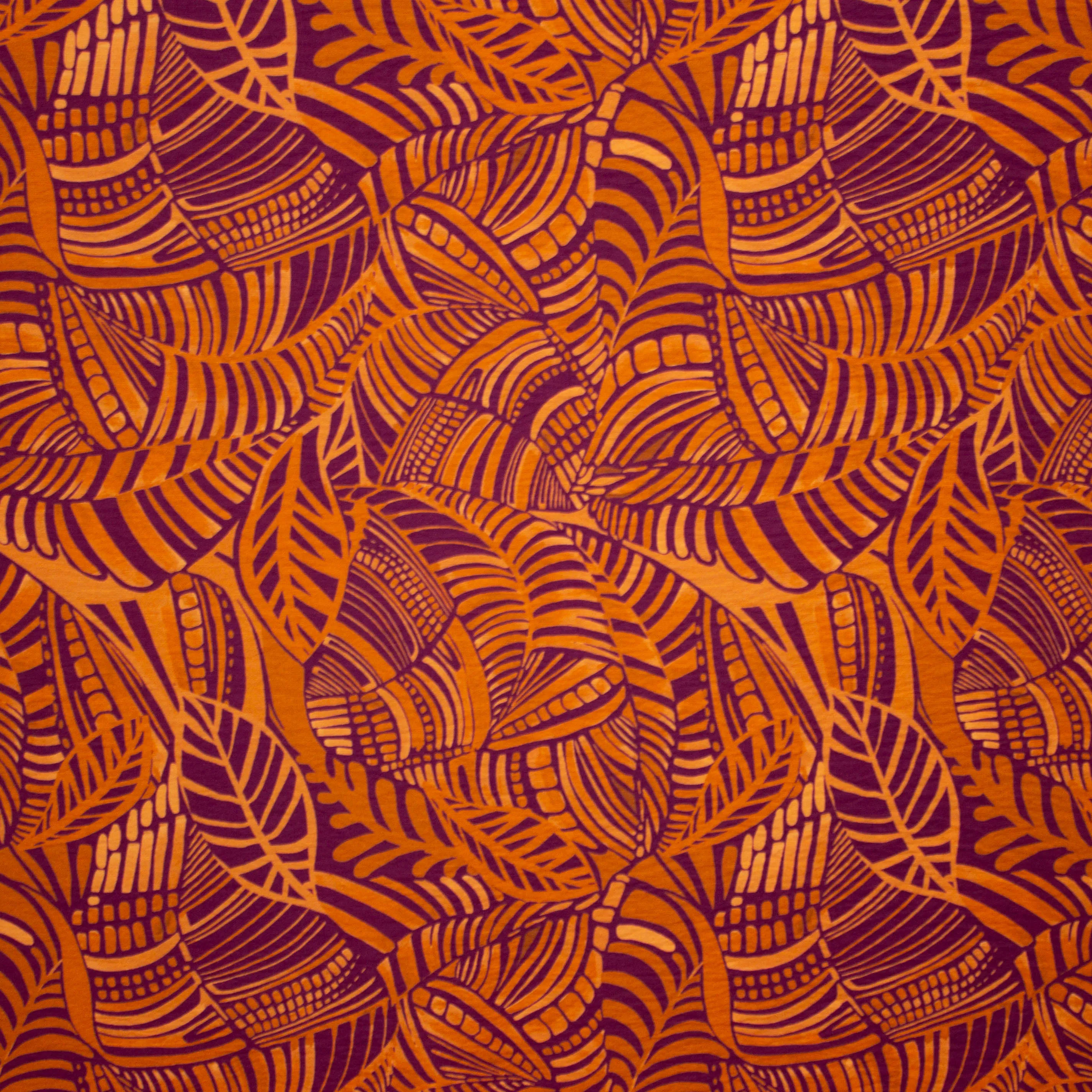 Viscose crêpe oranje met bladeren patroon