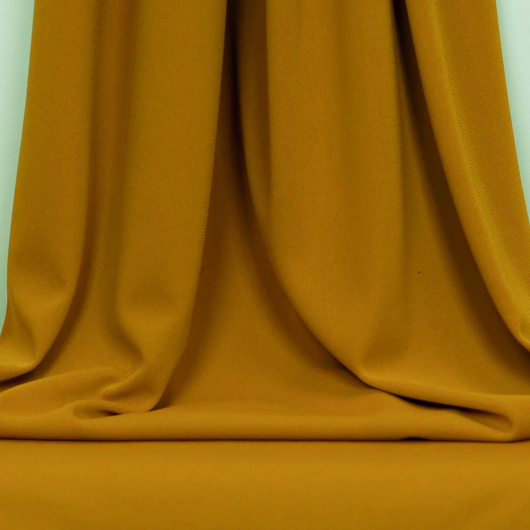 Polyester crêpe tricot mosterd effen