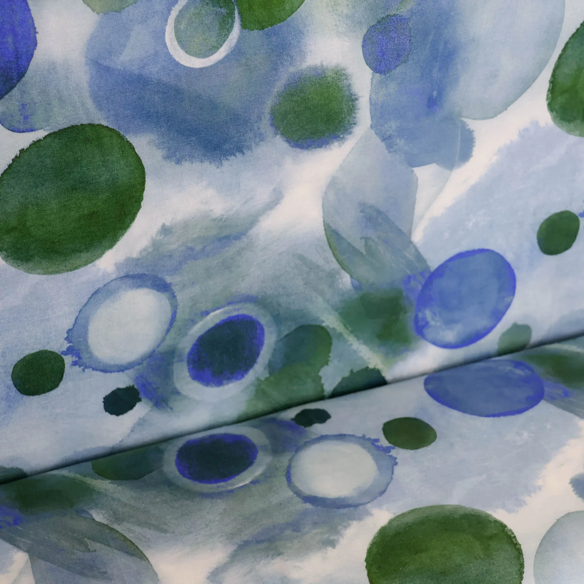 Lichte tricot met groen/blauwe bollen