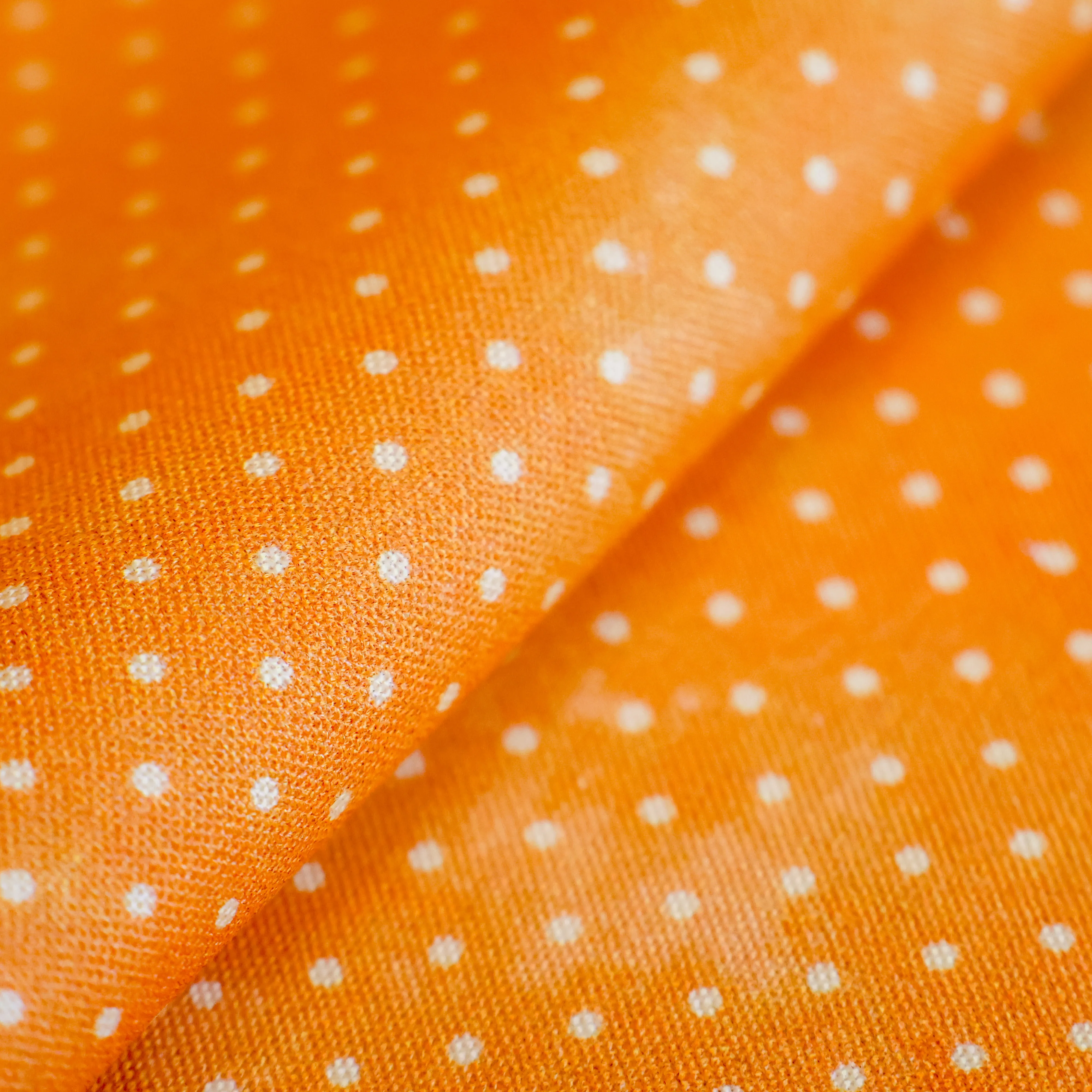 Katoen oranje met witte stippen
