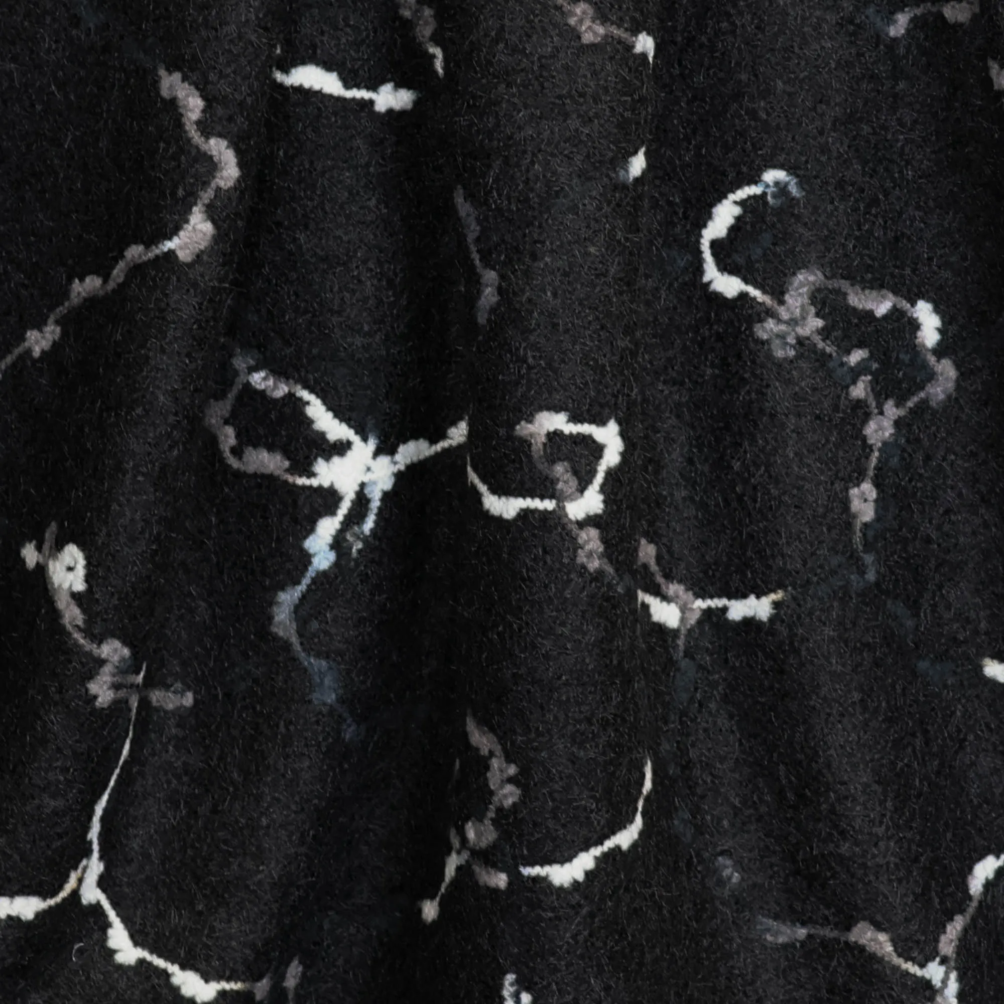 Mantelstof zwart met abstract motief - Knipmode