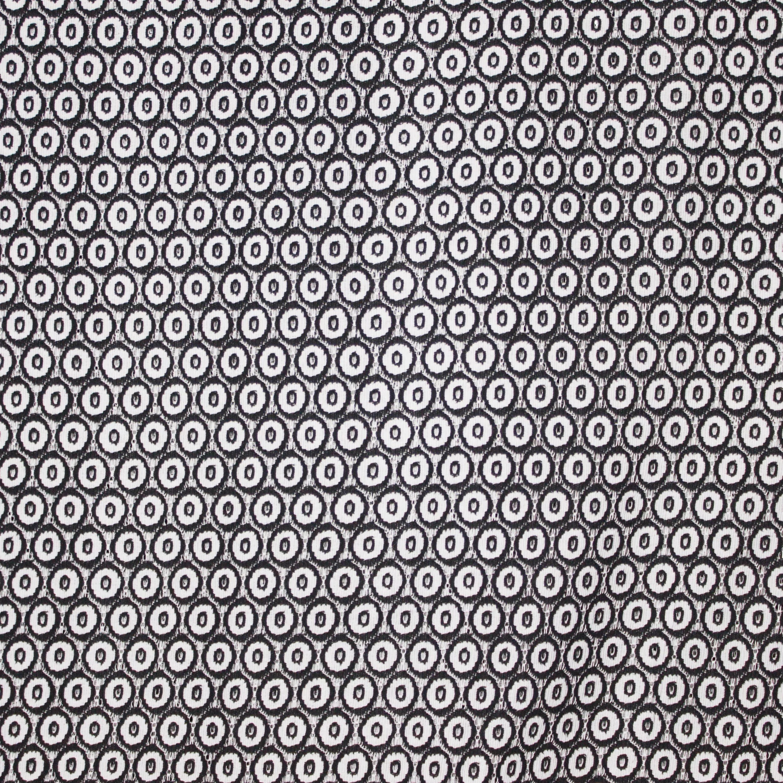 Polyester / nylon mengeling  met zwart en grijs bollen motief in kant look