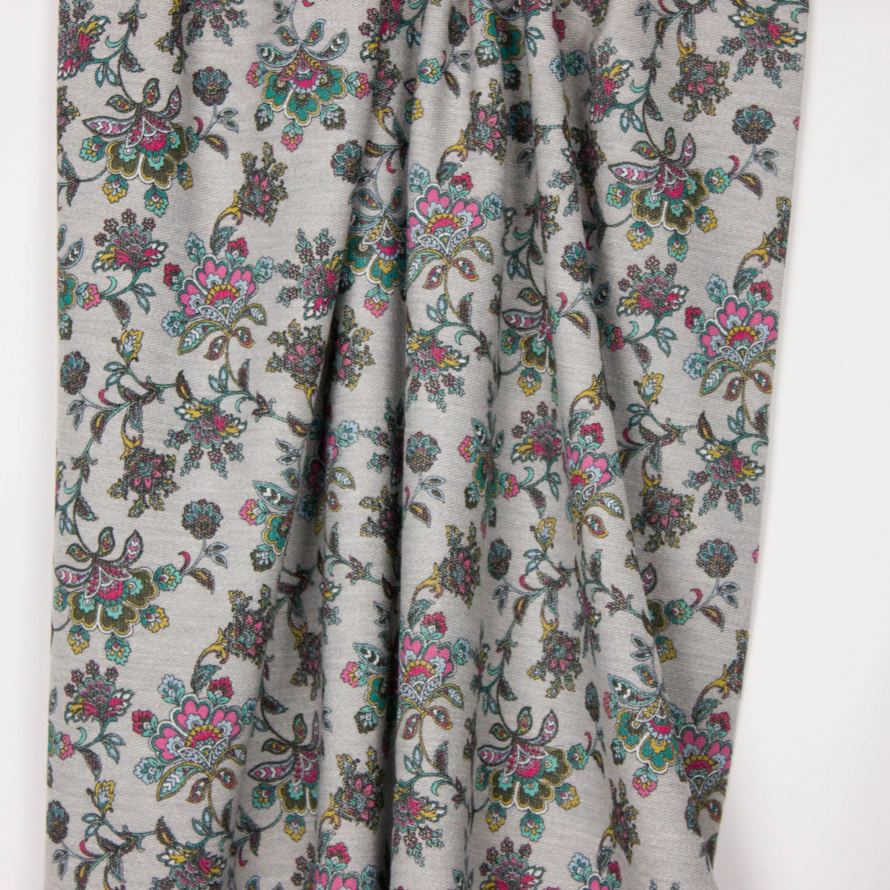 Grijze french terry met retro bloemenmotief op de lusjeszijde